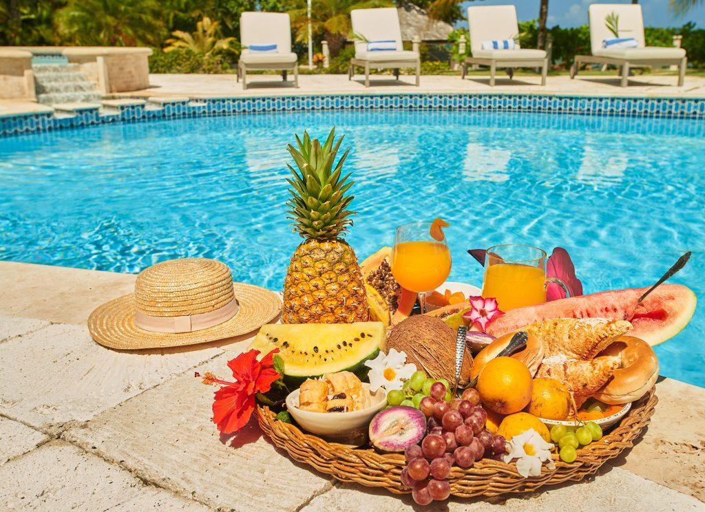 Tropical fruit breakfast and fresh juice served poolside at Breakaway Villa in Runaway Bay, Jamaica.