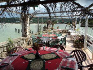 Seaside dining area at The Lobster Bowl Seafood Restaurant in Trelawny, Jamaica overlooking the ocean.