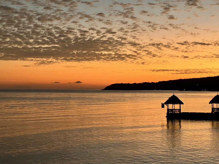 A stunning sunset over the Caribbean Sea in Jamaica.