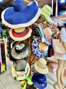 Colourful sun hats and beachwear at Andy’s Souvenirs in Taj Mahal Shopping Center Ocho Rios.