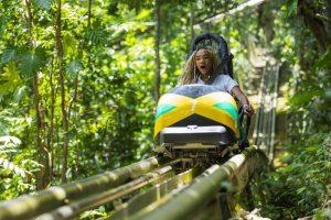 Guest riding bobsled through rainforest at Mystic Mountain Ocho Rios Jamaica.