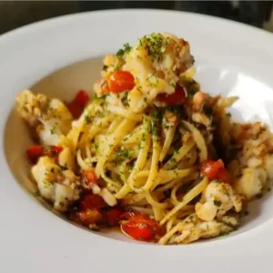 Lobster linguine with cherry tomatoes and fresh herbs at Ciao Bella Art Café Italian Restaurant in Ocho Rios, Jamaica.