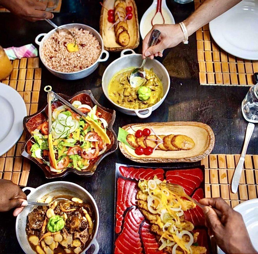Traditional Jamaican dishes including curried goat, oxtail, and escovitch fish at Miss T’s Kitchen restaurant in Ocho Rios, Jamaica