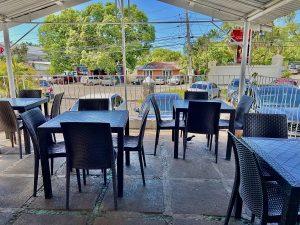 Covered outdoor dining at Family Essentials Jamaican Restaurant in Ocho Rios.